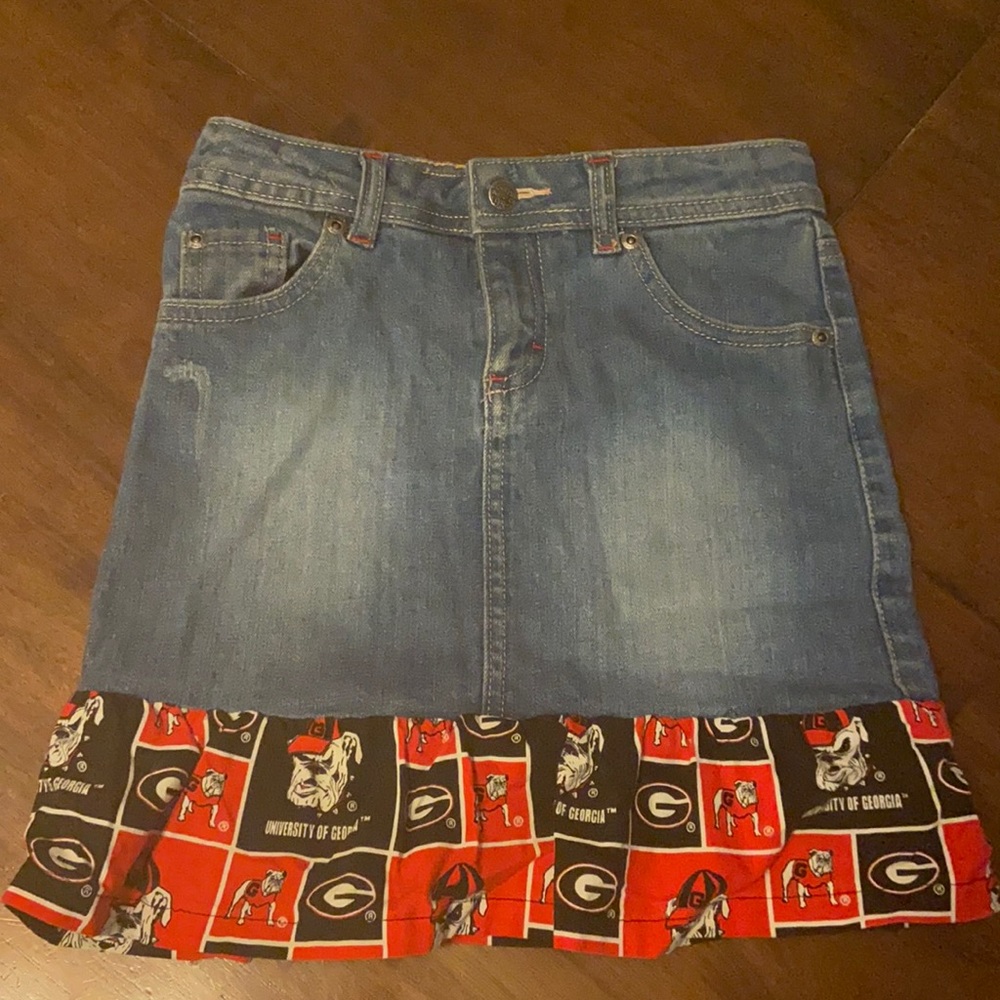 Size M Mossimo Denim Skirt with GA Bulldogs ruffled print on the bottom.